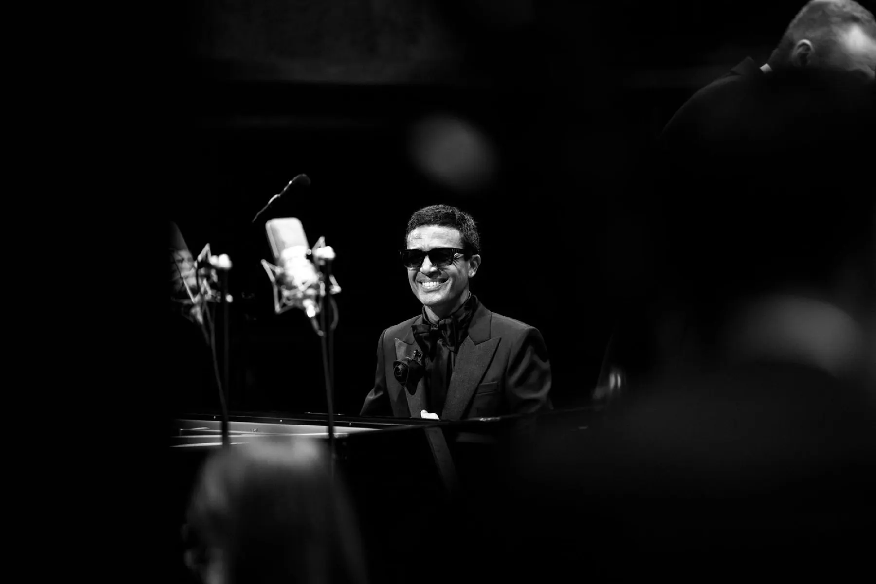 Omar Harfouch facing the audience in black and white