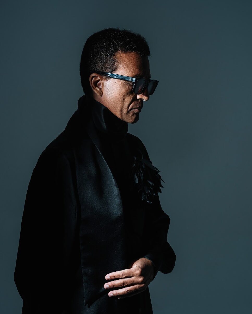 Omar Harfouch — dramatic side profile, dark teal