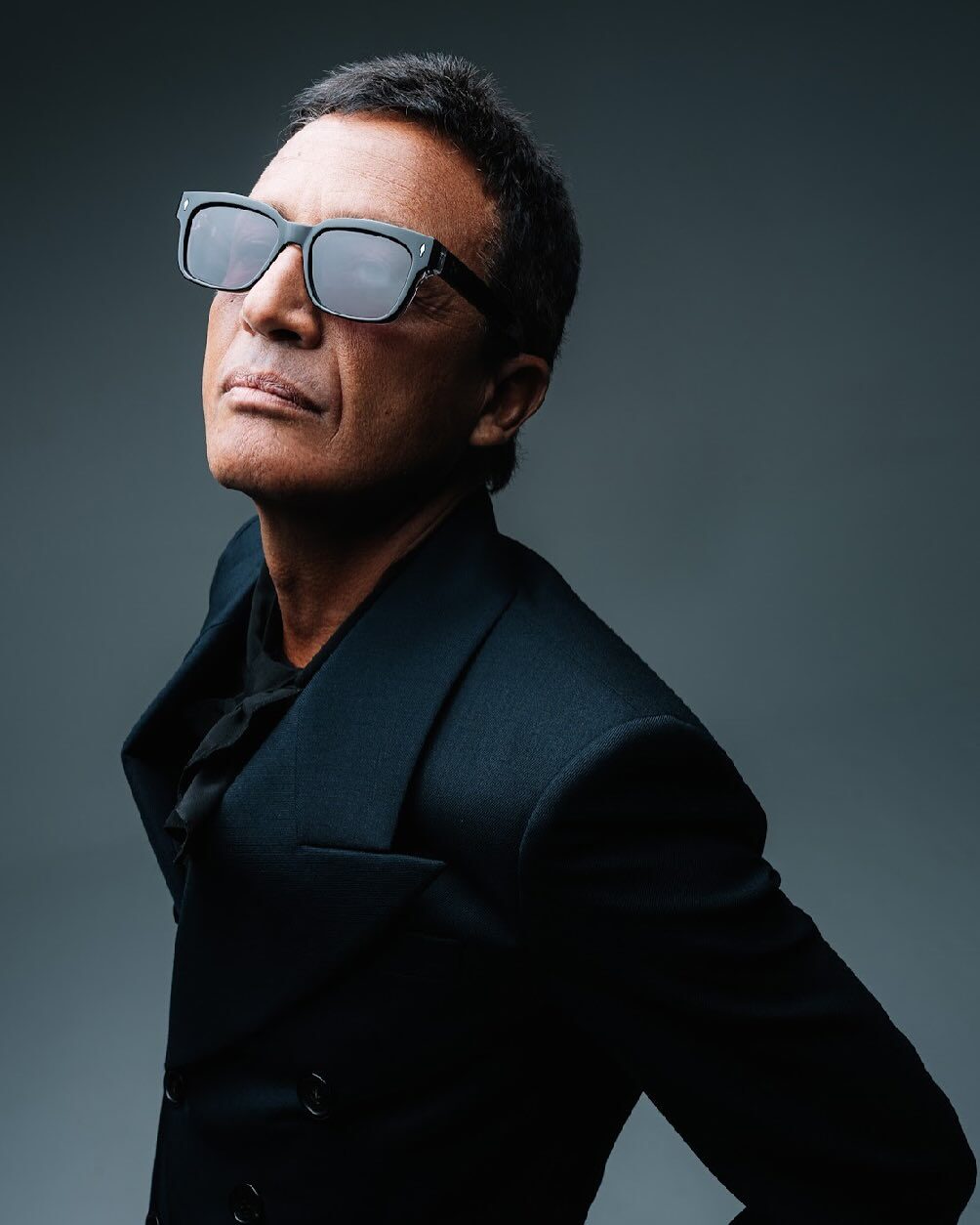 Omar Harfouch — editorial portrait, mirror sunglasses, looking upward